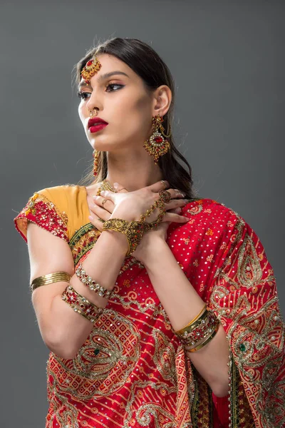 Beautiful indian woman in sari and accessories, isolated on grey — Stock Photo