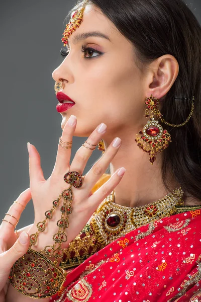 Beautiful indian woman gesturing in accessories, isolated on grey — Stock Photo