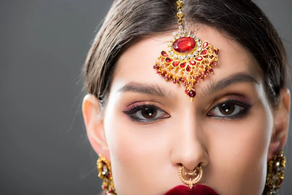 Attractive indian woman in traditional bindi, isolated on grey — Stock Photo