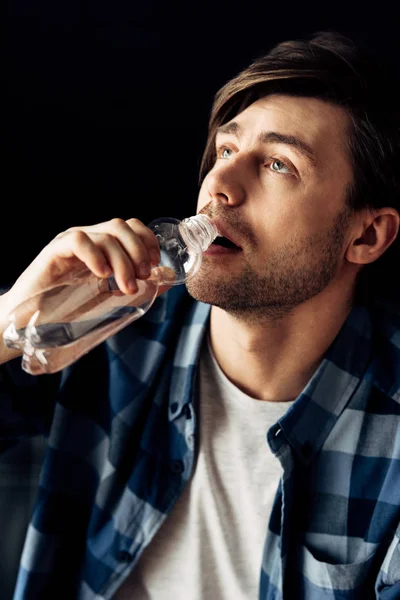 Man suffering from hangover drinking water after party — Stock Photo