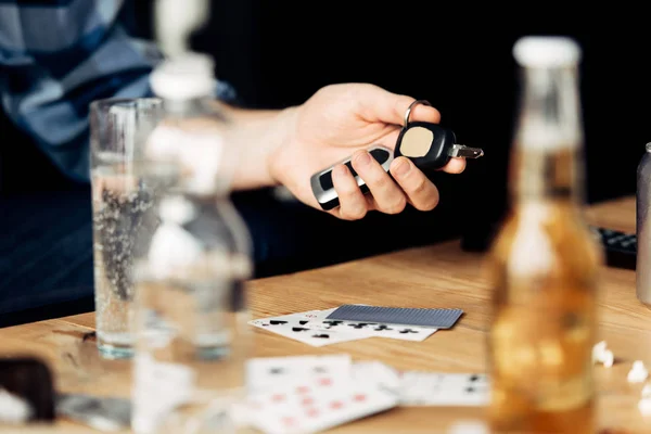 Cropped view of man holding car key after party — Stock Photo