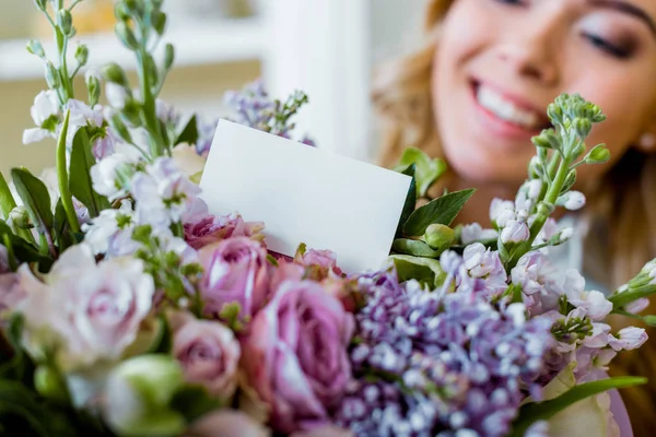 Vista recortada de mujer y ramo de flores con rosas, lila y tarjeta con espacio para copiar - foto de stock