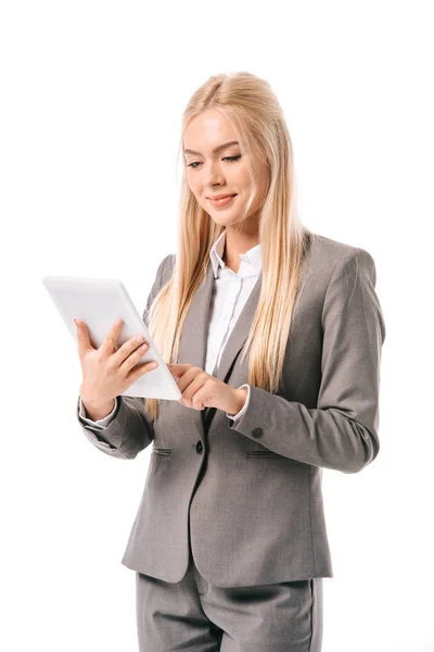 Smiling businesswoman working on digital tablet isolated on white — Stock Photo