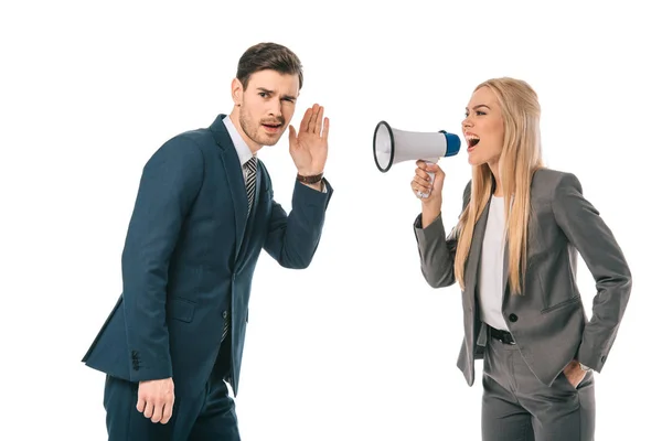 Businesswoman shouting into megaphone at male employee isolated on white — Stock Photo