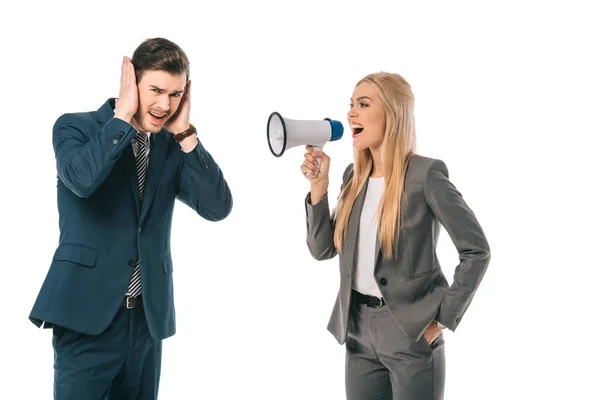 Beautiful female boss yelling into megaphone at scared male employee isolated on white — Stock Photo