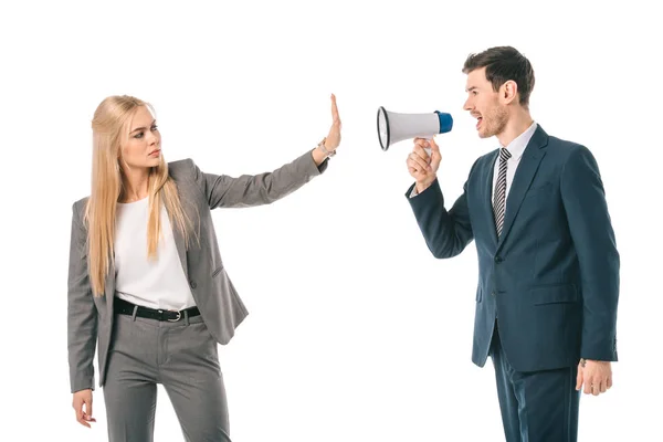 Businessman screaming into megaphone at businesswoman who showing stop gesture isolated on white, gender equality concept — Stock Photo