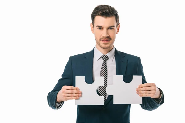 Handsome businessman holding puzzle pieces isolated on white, business idea concept — Stock Photo