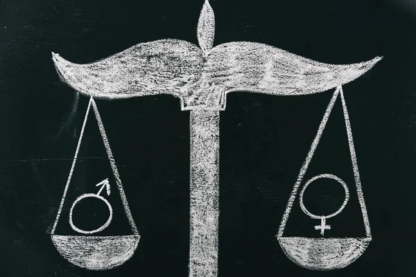 Male and female signs on scales drawing on chalkboard, gender equality concept — Stock Photo