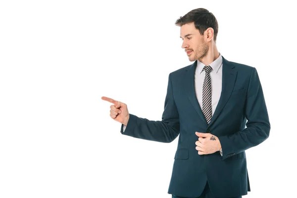 Hombre de negocios guapo apuntando a algo aislado en blanco - foto de stock