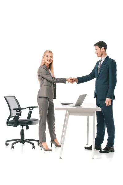 Business colleagues having deal at workplace with laptop, isolated on white — Stock Photo