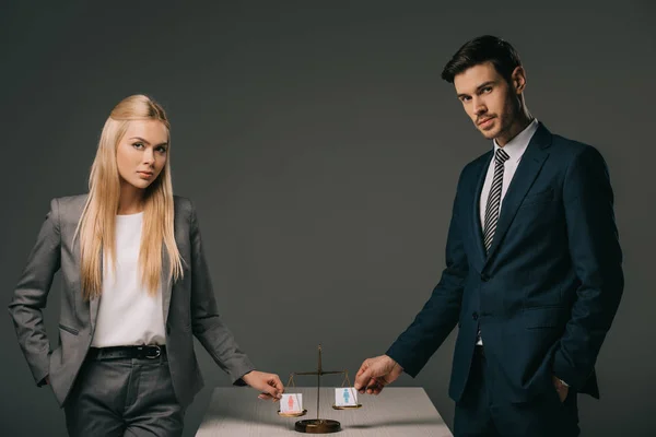 Professional businesspeople with male and female signs on scales of justice, gender equality concept — Stock Photo