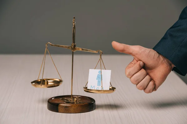 Partial view of businessman showing thumbs up near scales of justice and male signs, gender stereotypes concept — Stock Photo