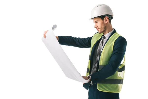 Handsome male architect in helmet and safety vest looking at blueprint, isolated on white — Stock Photo