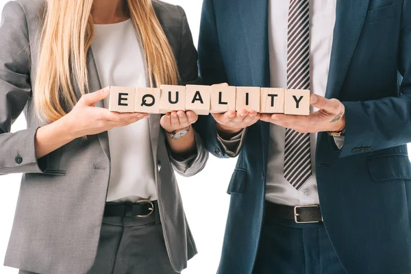 Cropped view of businesspeople holding alphabet cubes with equality word, isolated on white — Stock Photo