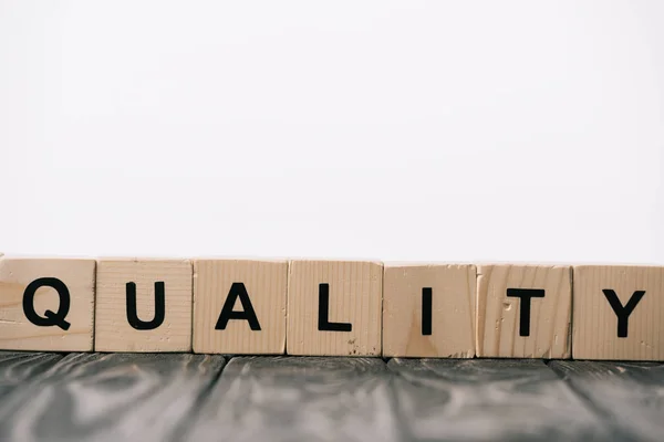Equality word made from alphabet cubes on wooden table on white — Stock Photo