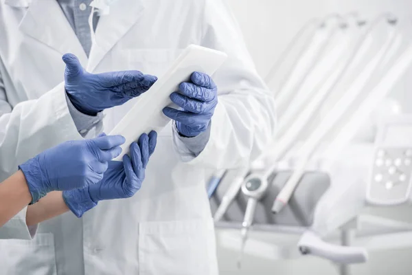 Cropped view of dentists standing with digital tablet in dental clinic — Stock Photo