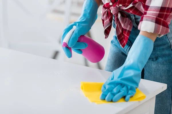 Vista recortada de la mesa de limpieza de mujer afroamericana en guantes de goma azul - foto de stock