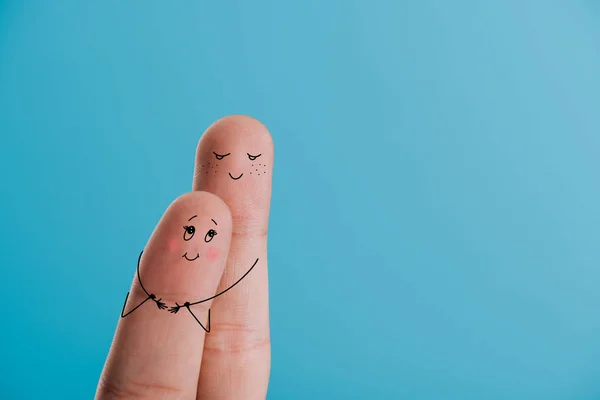 Partial view of happy couple of fingers hugging isolated on blue — Stock Photo