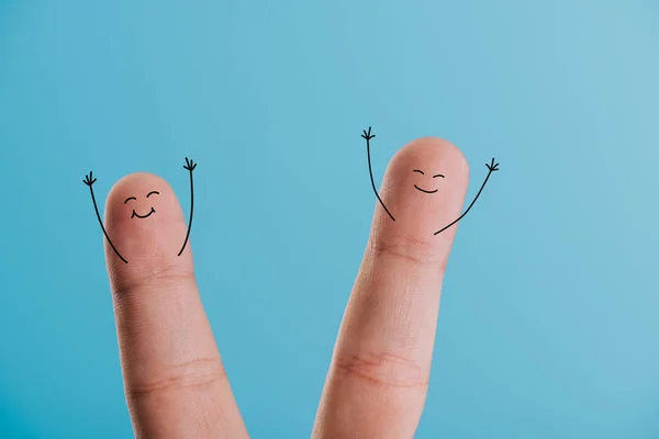 Cropped view of excited smiling fingers isolated on blue — Stock Photo