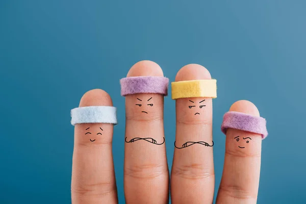 Cropped view of angry sporty fingers in headbands isolated on blue — Stock Photo