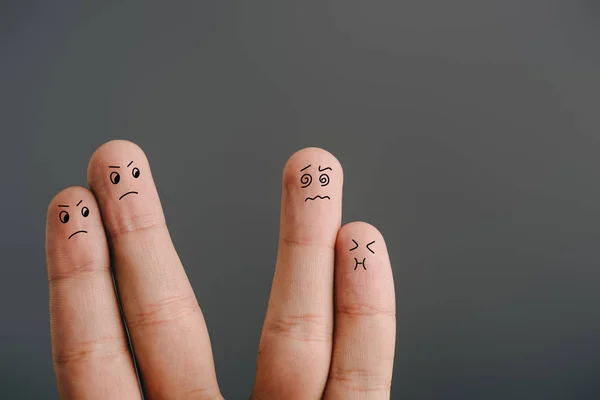 Cropped view of angry couple looking at confused fingers with nausea isolated on grey — Stock Photo