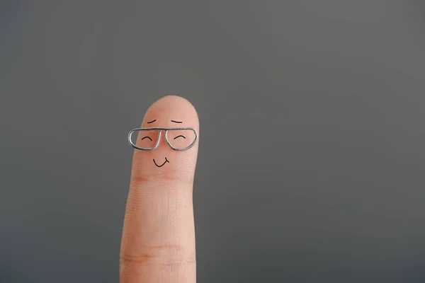 Cropped view of happy finger in eyeglasses isolated on grey — Stock Photo