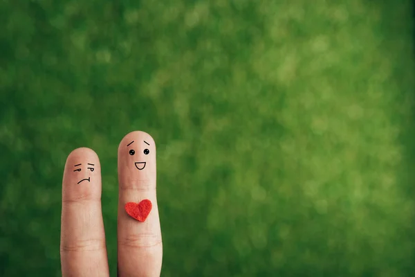 Cropped view of couple of fingers with heart isolated on blue — Stock Photo