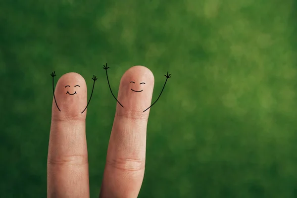 Cropped view of cheerful couple of fingers on green — Stock Photo