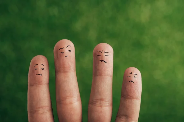 Cropped view of quarreling human fingers on green — Stock Photo