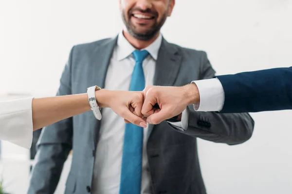 Cropped view of colleagues celebrating and smiling on white backgroung — Stock Photo