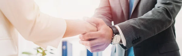 Cropped view of man and woman shaking hands at office — Stock Photo