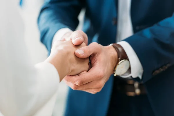 Selective focus of men and woman shaking hands at office — Stock Photo