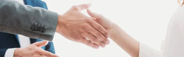 Selective focus of men and woman shaking hands at office — Stock Photo