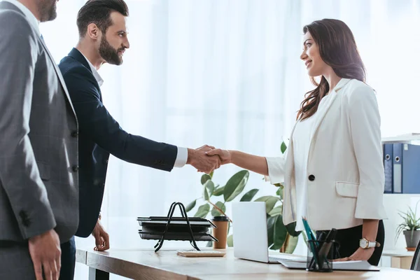 Advisor and investor in suits shaking hands at office — Stock Photo