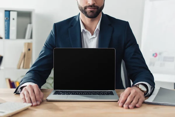 Cropped view of advisor in suit showing laptop with copy space — Stock Photo