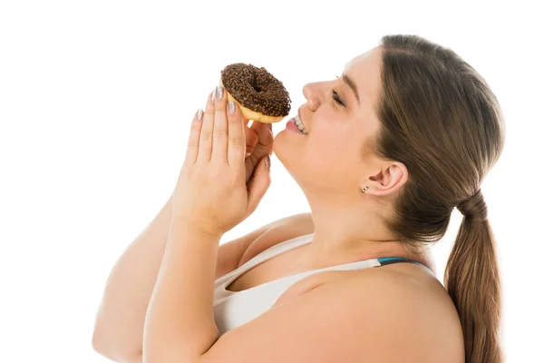 Happy overweight woman looking at sweet doughnut isolated on white, body positivity concept — Stock Photo