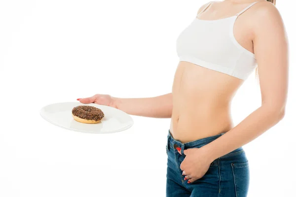 Partial view of slim woman holding sweet delicious doughnut on plate isolated on white — Stock Photo