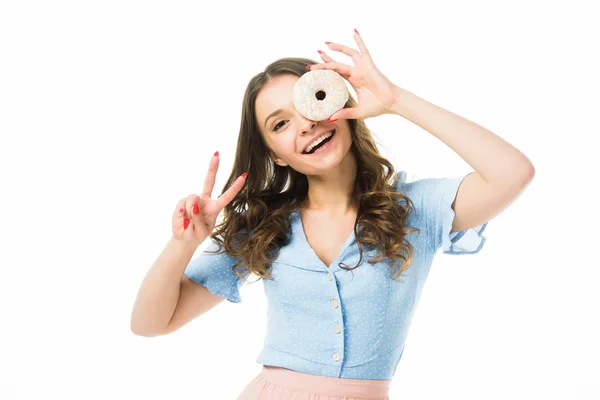 Happy smiling beautiful girl with donghnut showing victory sign isolated on white — стоковое фото