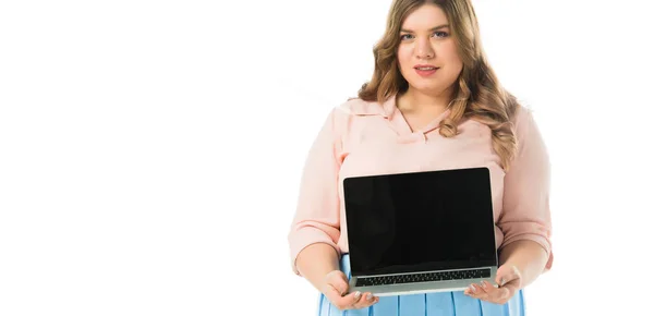 Attractive elegant plus size girl showing laptop with blank screen isolated on white — Stock Photo