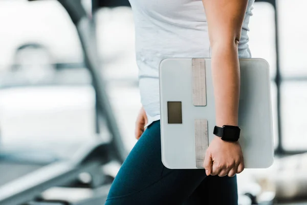 Cropped view of overweight woman holding scales — Stock Photo