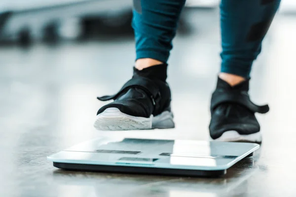 Cropped view of plus size woman standing on scales — Stock Photo