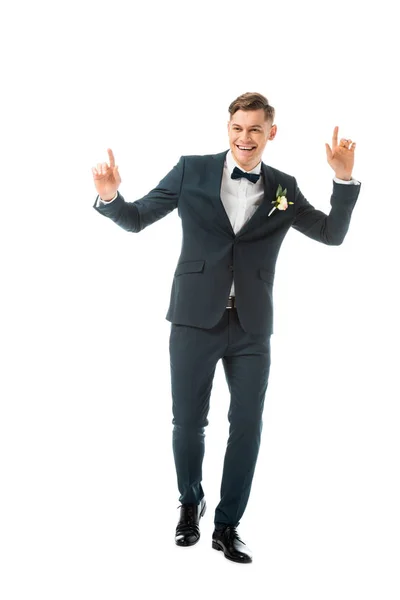 Cheerful dancing groom in black suit isolated on white — Stock Photo