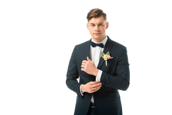 Confident handsome bridegroom in black elegant suit isolated on white — Stock Photo