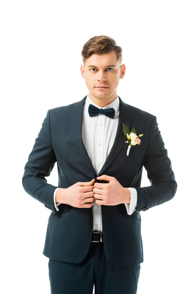 Serious bridegroom in elegant black suit isolated on white — Stock Photo