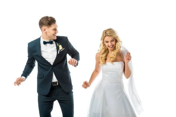 Cheerful smiling groom dancing with happy bride isolated on white — Stock Photo