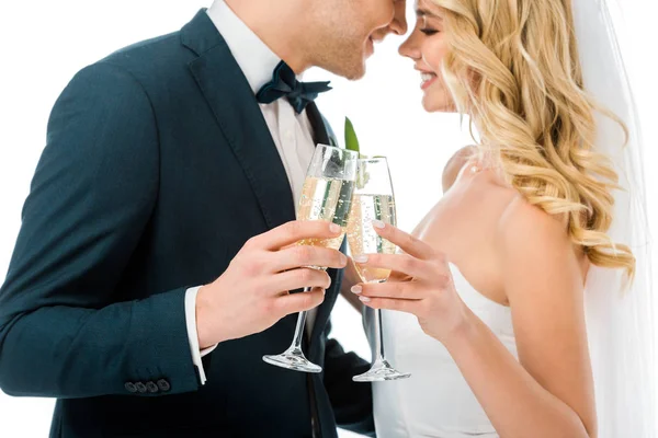 Heureux mariée et marié cliquetis verres de champagne tout en se tenant face à face isolé sur blanc — Photo de stock