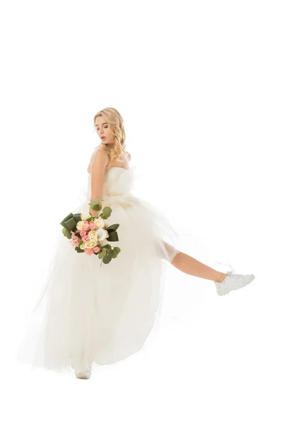 Pretty happy bride posing in wedding dress and sneakers isolated on white — Stock Photo