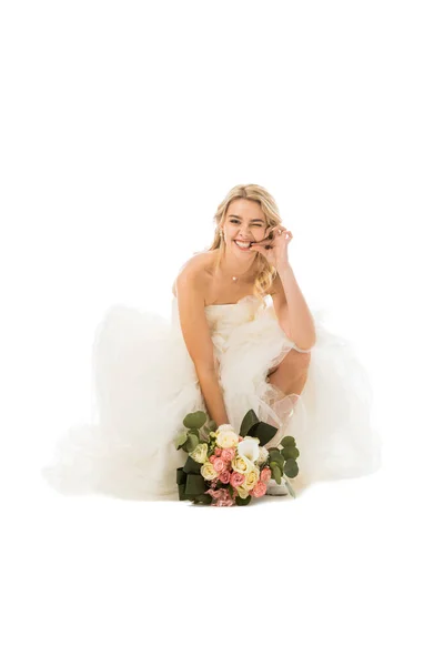 Tricky cheerful bride funny grimacing and holding wedding bouquet isolated on white — Stock Photo