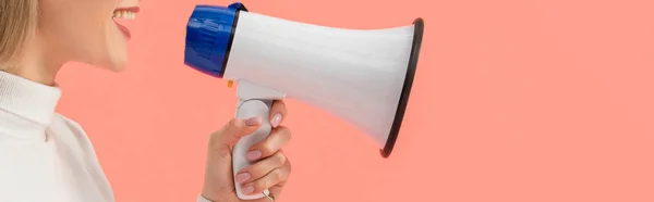Panoramic shot of woman speaking in megaphone isolated on pink — Stock Photo