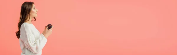 Panoramic shot of surprised girl holding joystick while standing isolated on pink — Stock Photo